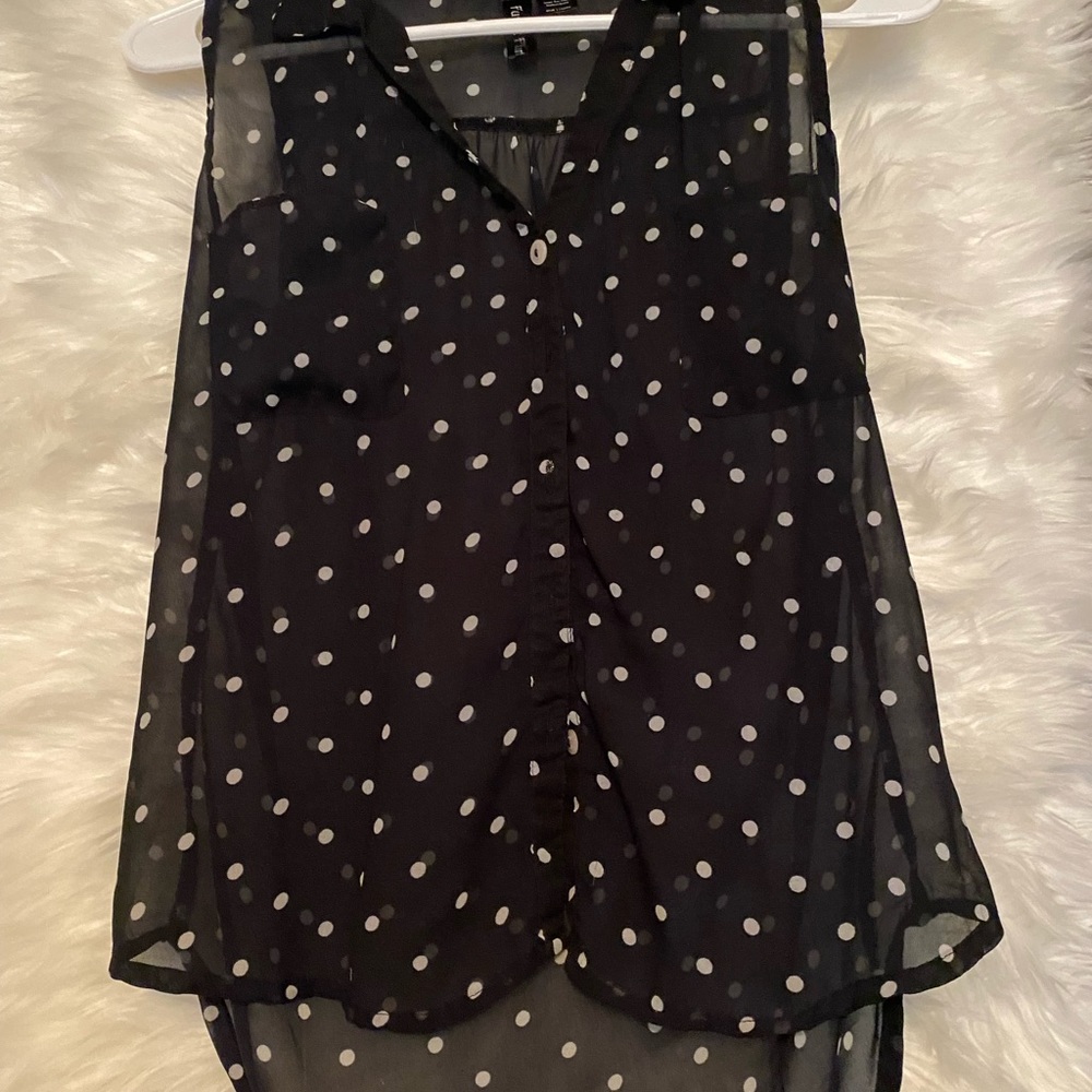 Sleeveless black and white polka dot blouse